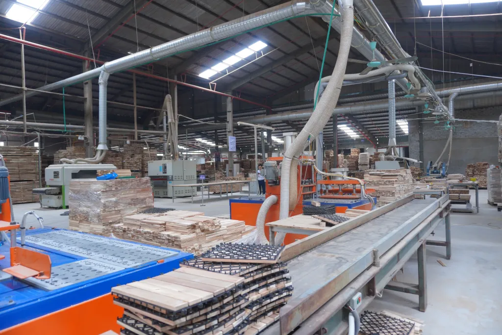 Conveyor carrying assembled decking tiles