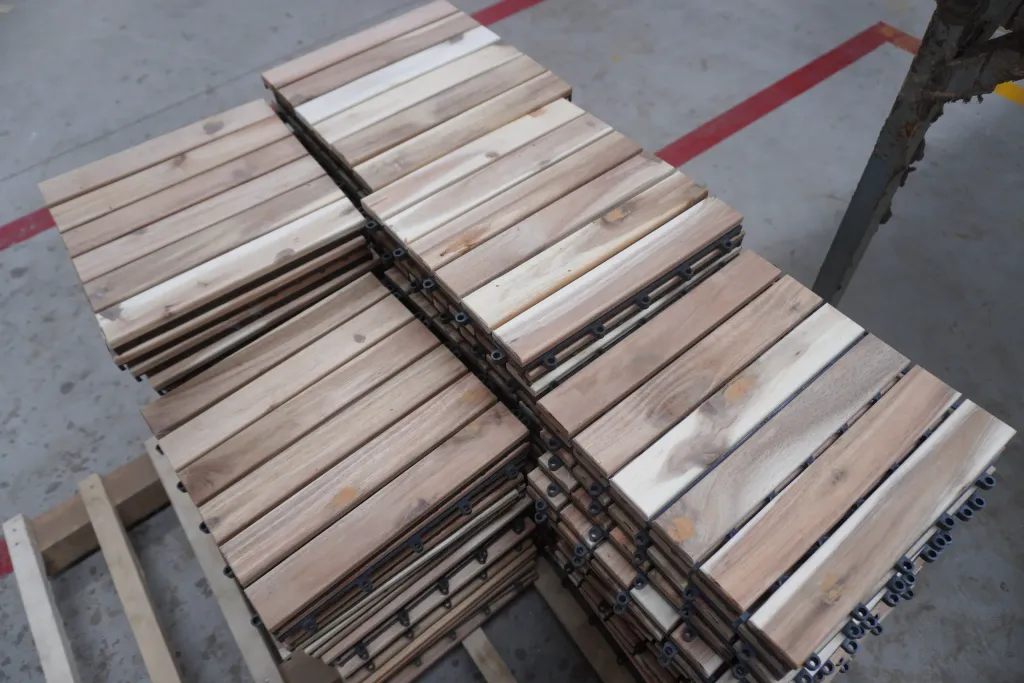 Acacia decking tiles stacked on the factory floor