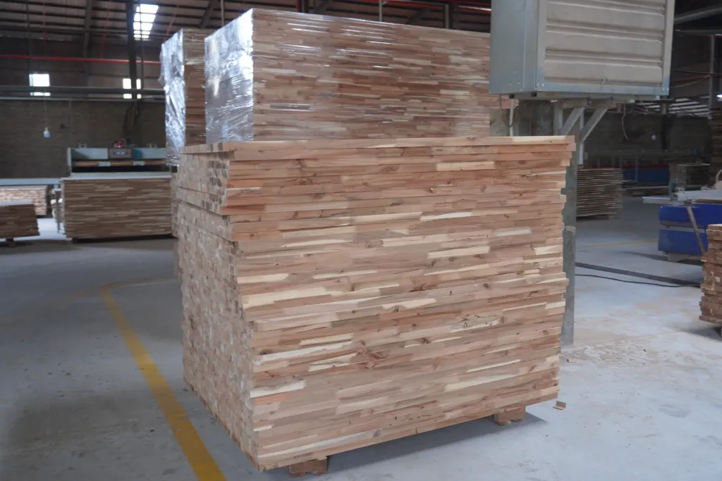 Stack of edge-glued acacia panels on the factory floor