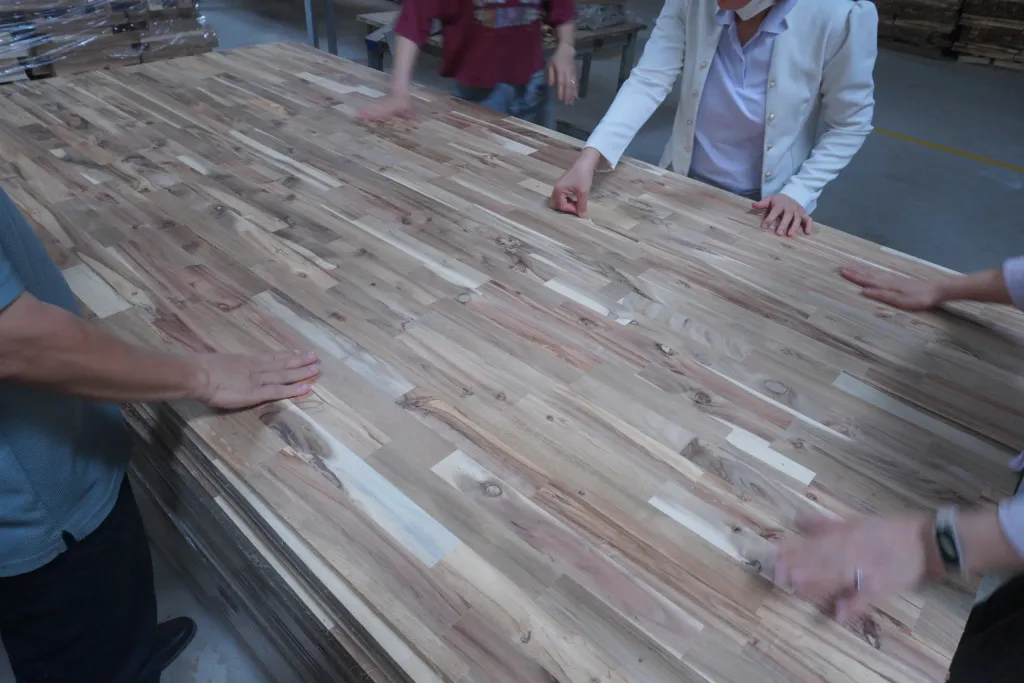 Hands checking the surface of an acacia panel
