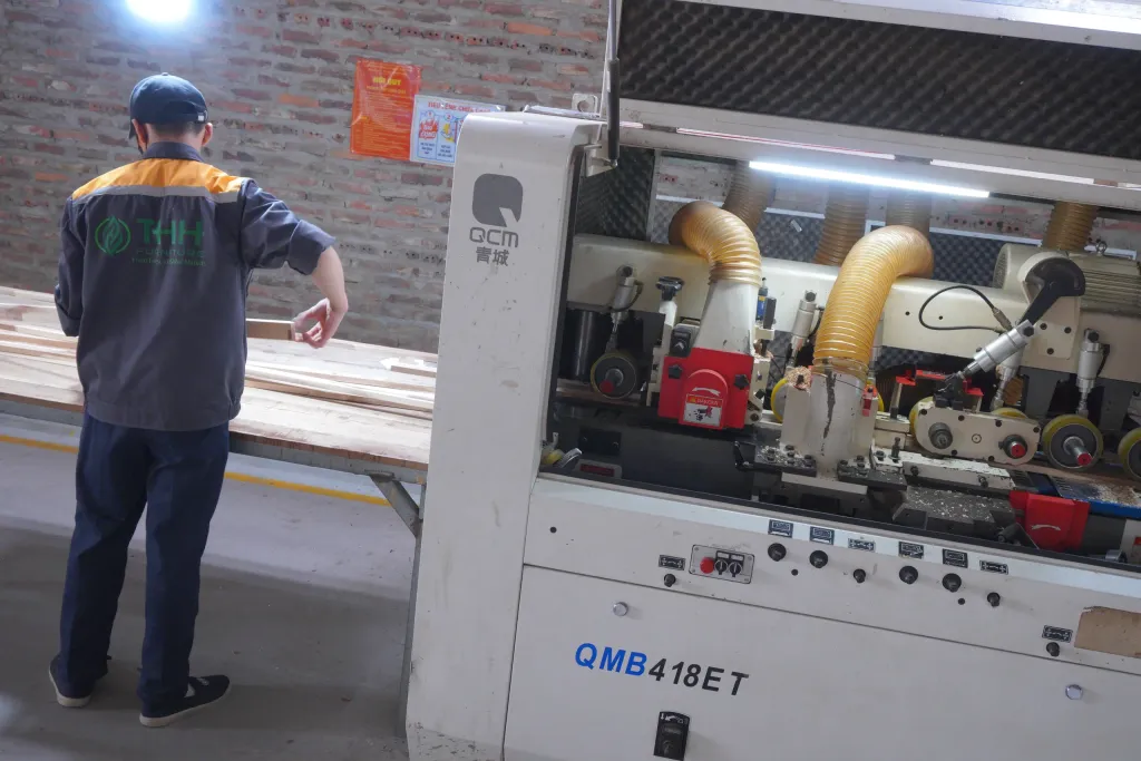 Operator feeding boards into a four-sided moulder