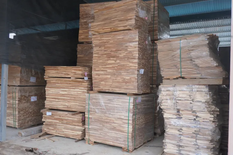 Strapped board packs stored under a shed