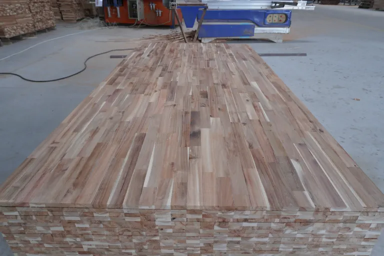 Sanded finger-jointed acacia panel on top of a stack