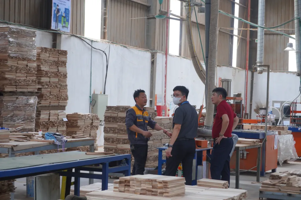 Three supervisors talking on the production floor