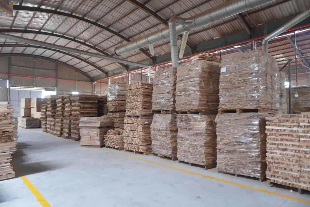 Warehouse aisle lined with stretch-wrapped wood stock