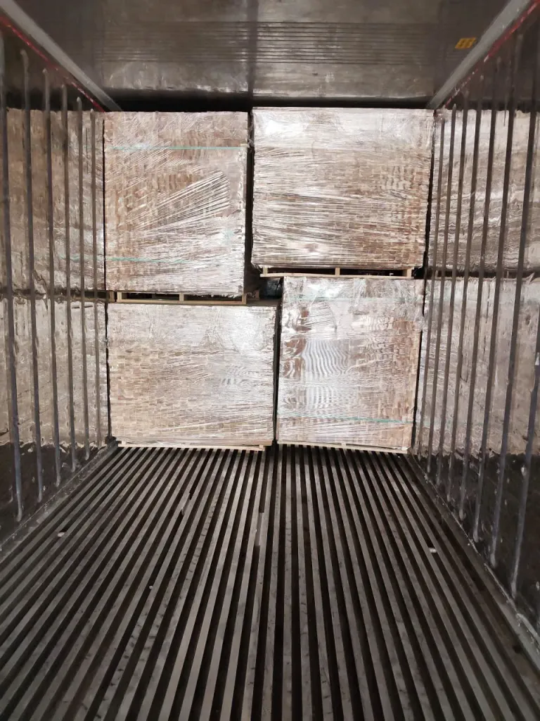 Stretch-wrapped pallets stacked two high inside a container